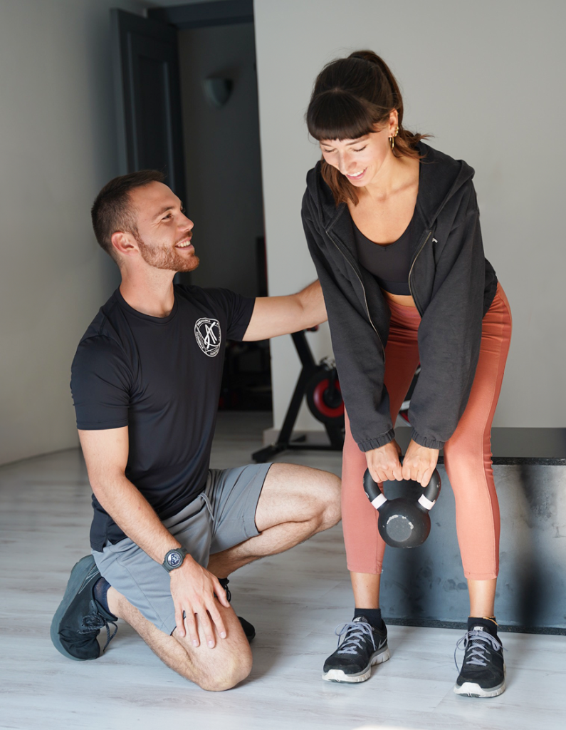 Andrea Tortorella trains a woman in a gym