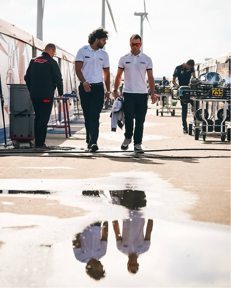 Andrea Tortorella walking with a karting team colleague during a race weekend in the paddock